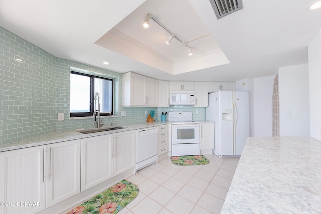 kitchen with sink, backsplash, white appliances, a raised ceiling, and white cabinets