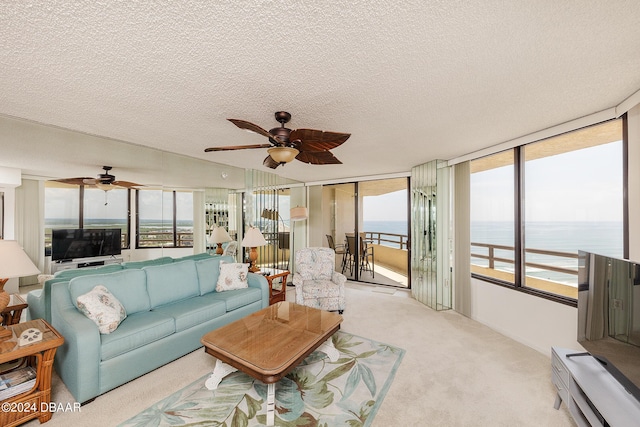 3855 S Atlantic Ave Unit 1206B, Daytona Beach Shores, FL 32118 - living area featuring ceiling fan, light colored carpet, and a textured ceiling