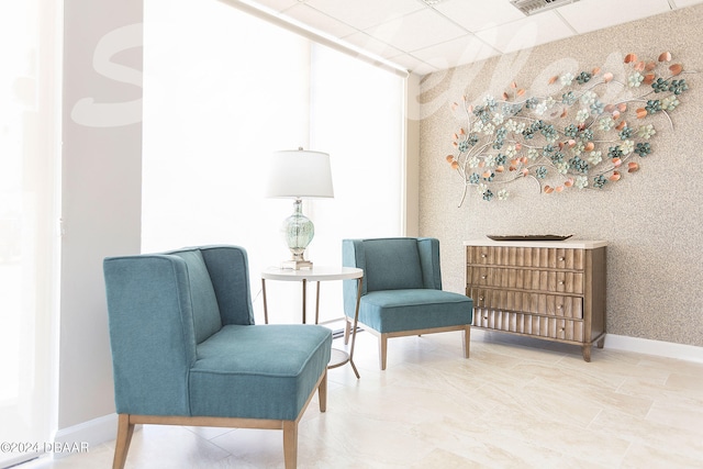 sitting room featuring a paneled ceiling