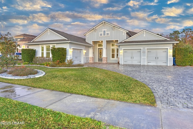 view of front of house with a garage and a front lawn