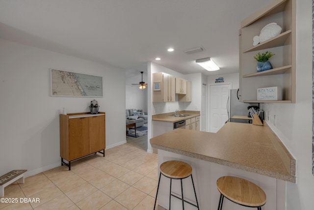 805 Spruce St, New Smyrna Beach, FL 32168 - kitchen featuring open shelves, freestanding refrigerator, a peninsula, a breakfast bar area, and recessed lighting