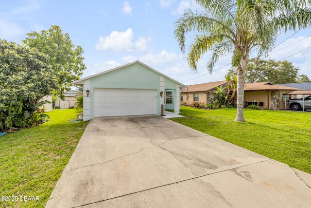805 Spruce St, New Smyrna Beach, FL 32168 - view of front of house with a front lawn, stucco siding, and driveway