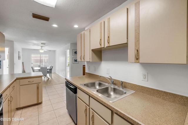 805 Spruce St, New Smyrna Beach, FL 32168 - kitchen with dishwasher, cream cabinets, light tile patterned floors, recessed lighting, and light countertops