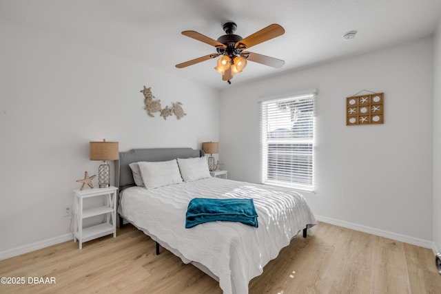 805 Spruce St, New Smyrna Beach, FL 32168 - bedroom with light wood-style flooring and ceiling fan