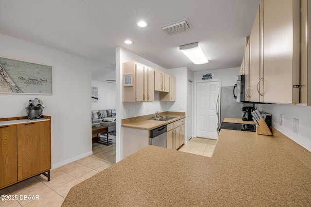 805 Spruce St, New Smyrna Beach, FL 32168 - kitchen featuring appliances with stainless steel finishes, light tile patterned flooring, light countertops, recessed lighting, and a peninsula