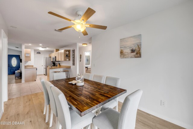 805 Spruce St, New Smyrna Beach, FL 32168 - dining room featuring ceiling fan and light wood-style flooring