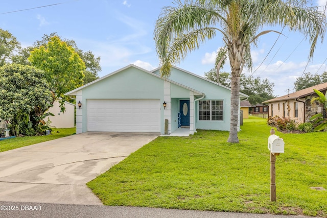 805 Spruce St, New Smyrna Beach, FL 32168 - view of front of home featuring stucco siding, a garage, driveway, and a front lawn