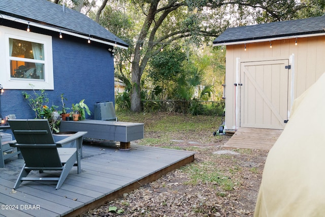 wooden deck featuring a storage unit