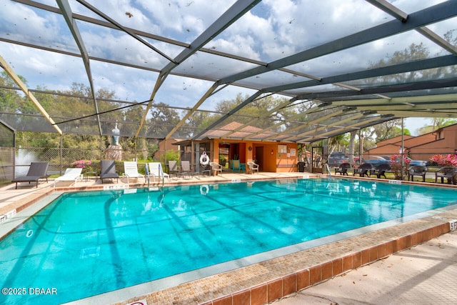 pool with glass enclosure, a patio, and fence