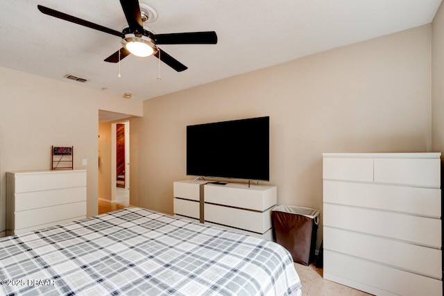 bedroom featuring light tile patterned floors, visible vents, and ceiling fan