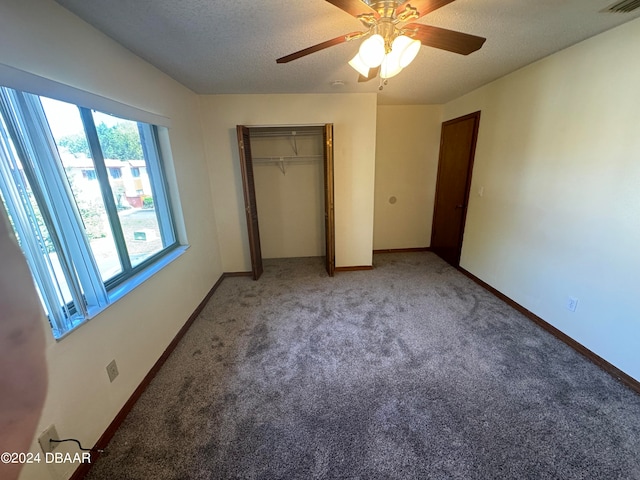 unfurnished bedroom featuring a textured ceiling, carpet flooring, and ceiling fan