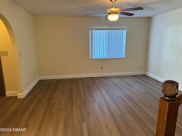 empty room featuring hardwood / wood-style flooring, ceiling fan, and a textured ceiling