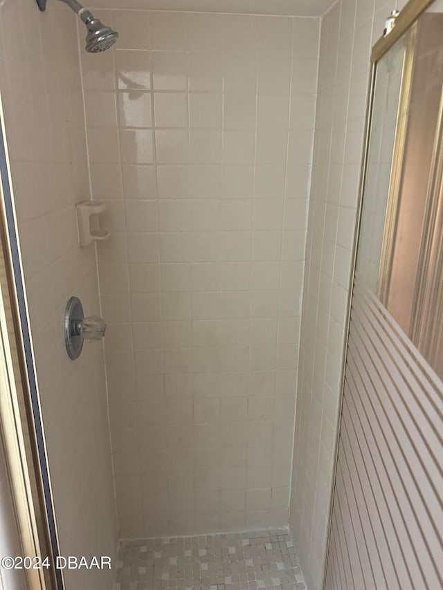 bathroom with tiled shower