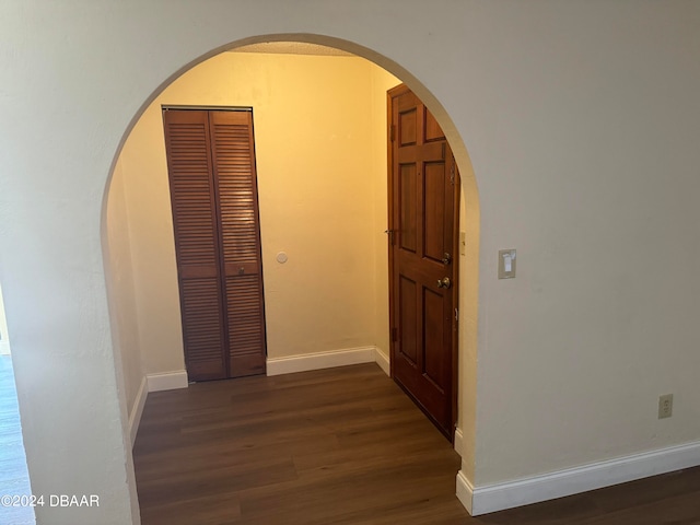 hall with dark wood-type flooring