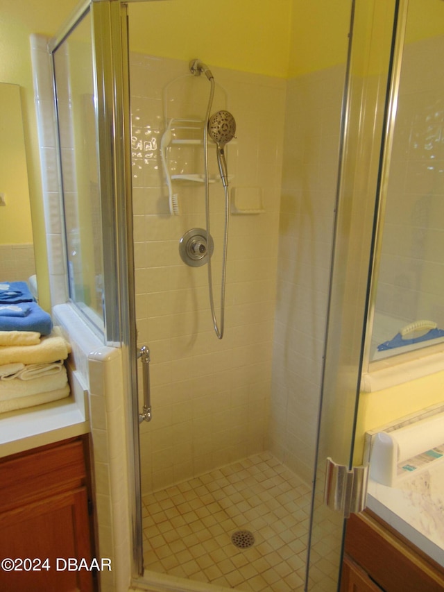 bathroom with walk in shower and vanity