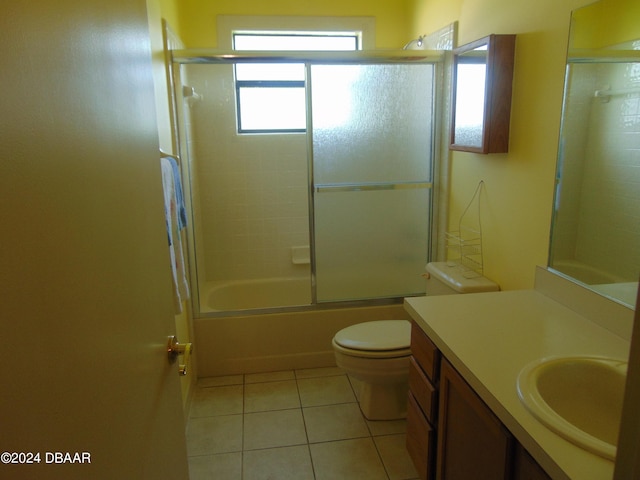 full bathroom featuring toilet, shower / bath combination with glass door, tile patterned floors, and vanity