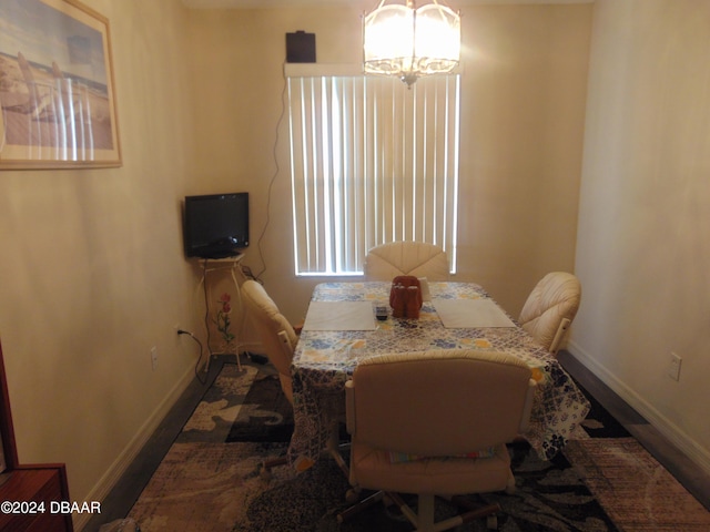 dining space featuring hardwood / wood-style flooring and a notable chandelier