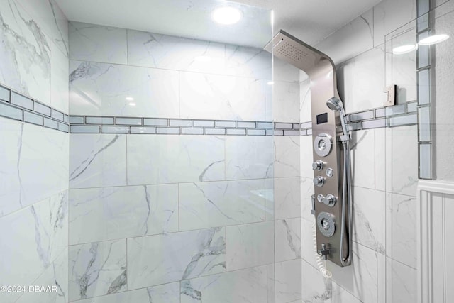 bathroom with tiled shower