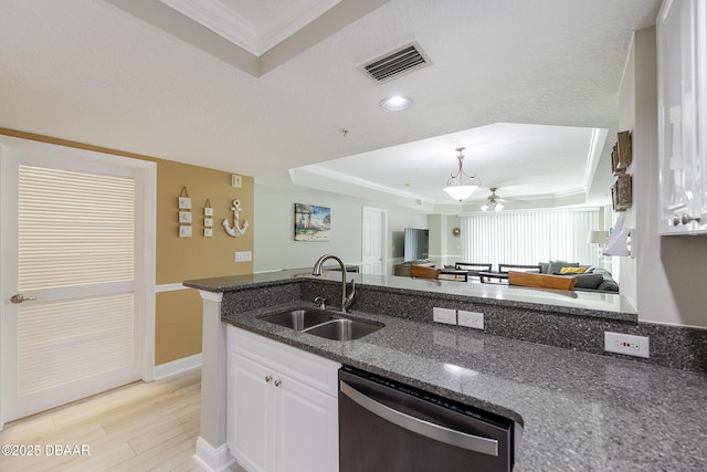 4650 Links Village Dr Unit C-505, Ponce Inlet, FL 32127 - kitchen with stainless steel dishwasher, a tray ceiling, a sink, dark stone countertops, and crown molding
