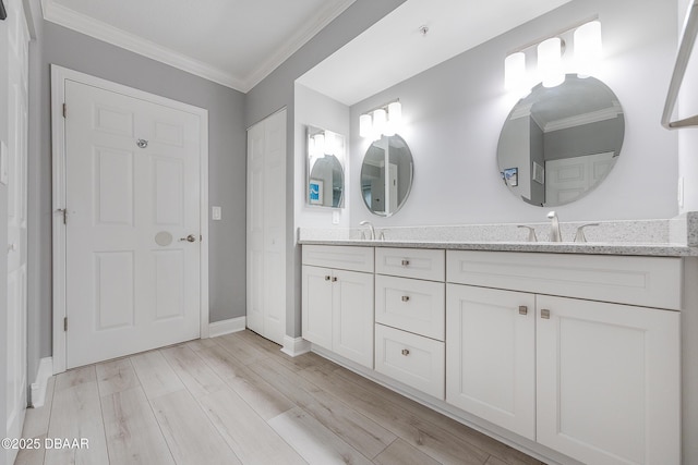 4650 Links Village Dr Unit C-505, Ponce Inlet, FL 32127 - bathroom with double vanity, ornamental molding, wood finished floors, and baseboards