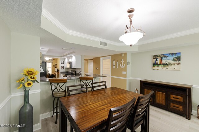 4650 Links Village Dr Unit C-505, Ponce Inlet, FL 32127 - dining room with light wood-style floors, crown molding, and baseboards