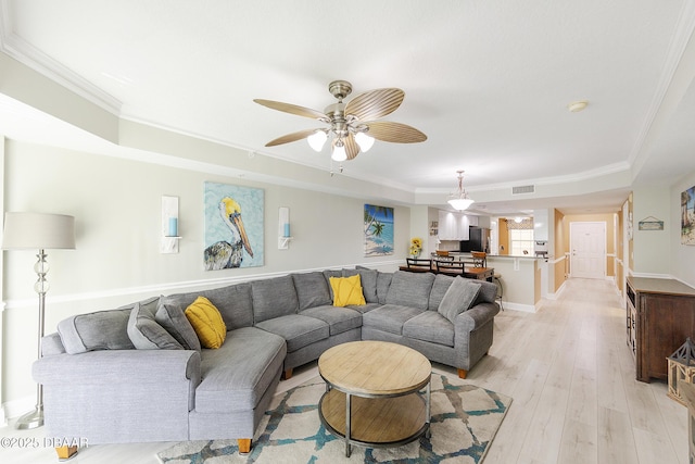 4650 Links Village Dr Unit C-505, Ponce Inlet, FL 32127 - living area with a tray ceiling, light wood-style floors, a ceiling fan, ornamental molding, and baseboards