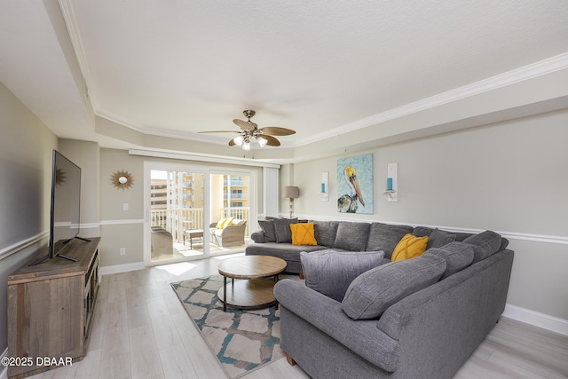4650 Links Village Dr Unit C-505, Ponce Inlet, FL 32127 - living area featuring a raised ceiling, a ceiling fan, light wood-type flooring, crown molding, and baseboards