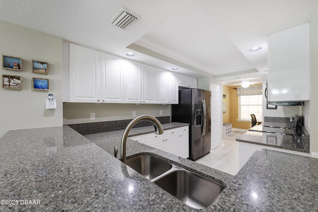 4650 Links Village Dr Unit C-505, Ponce Inlet, FL 32127 - kitchen featuring black refrigerator with ice dispenser, a sink, range, white cabinetry, and recessed lighting