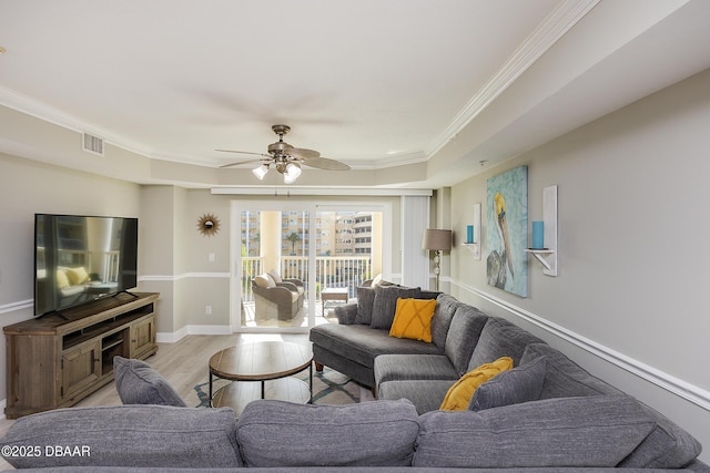 4650 Links Village Dr Unit C-505, Ponce Inlet, FL 32127 - living room with crown molding, ceiling fan, light wood-style flooring, baseboards, and a raised ceiling