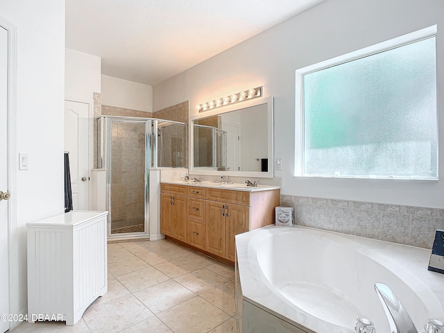 bathroom with tile patterned floors, vanity, and independent shower and bath