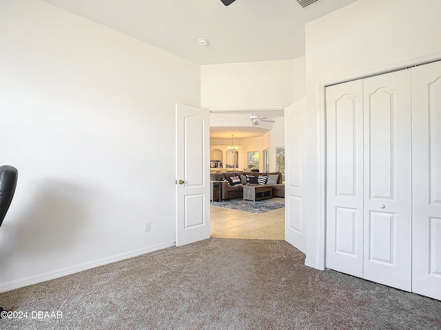 interior space featuring carpet, a notable chandelier, and a closet