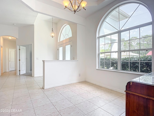 dining area with a chandelier and light tile patterned flooring