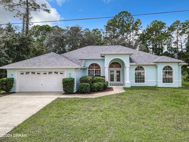 single story home featuring a front yard, french doors, and a garage