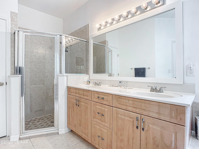 bathroom featuring tile patterned flooring, vanity, and a shower with door