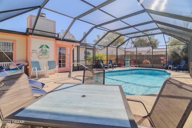 view of swimming pool featuring a lanai and a patio area