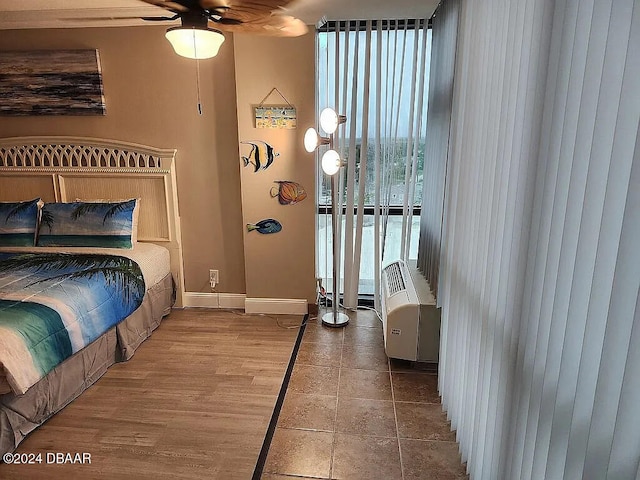 bedroom with hardwood / wood-style floors and ceiling fan