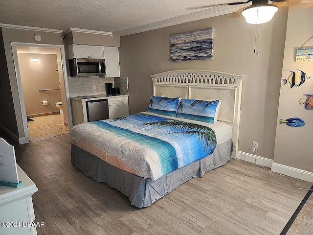 bedroom featuring ensuite bathroom, ceiling fan, light hardwood / wood-style flooring, and ornamental molding