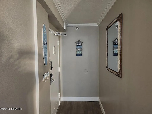 hallway with ornamental molding, dark hardwood / wood-style flooring, and a textured ceiling