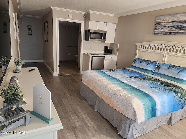 bedroom featuring stainless steel refrigerator, ornamental molding, and light hardwood / wood-style flooring