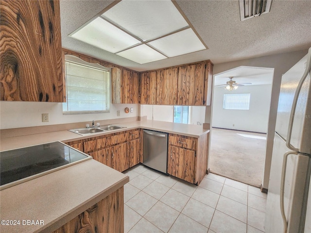 kitchen with black electric stovetop, stainless steel dishwasher, sink, light tile patterned floors, and white refrigerator