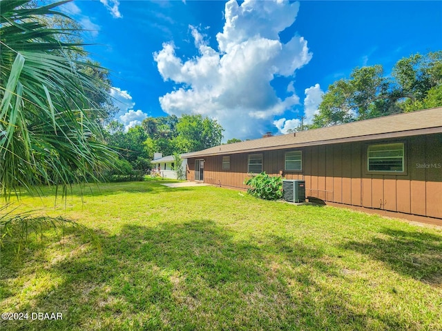 1119 Indigo Rd, Ormond Beach, FL 32174 - view of green lawn featuring central AC unit