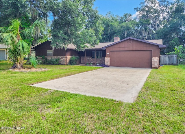 single story home featuring a garage and a front yard