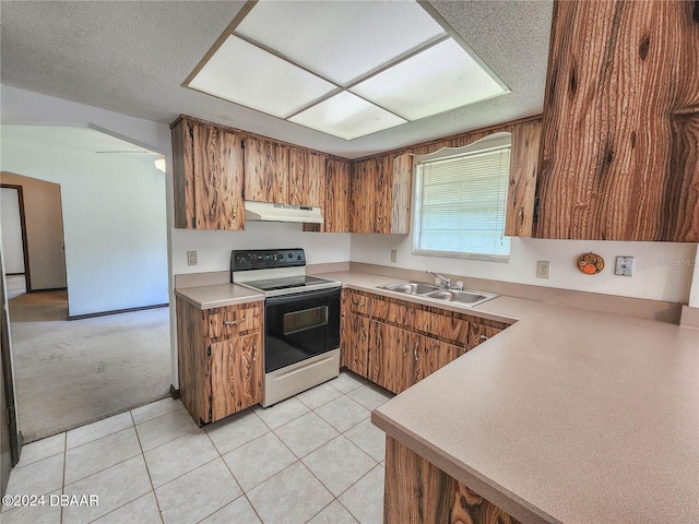 kitchen with a textured ceiling, light tile patterned floors, sink, and electric range oven