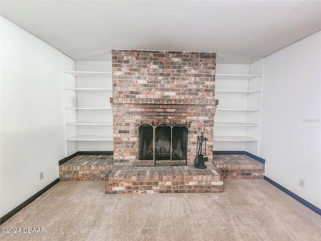 unfurnished living room featuring a brick fireplace, a textured ceiling, and carpet flooring