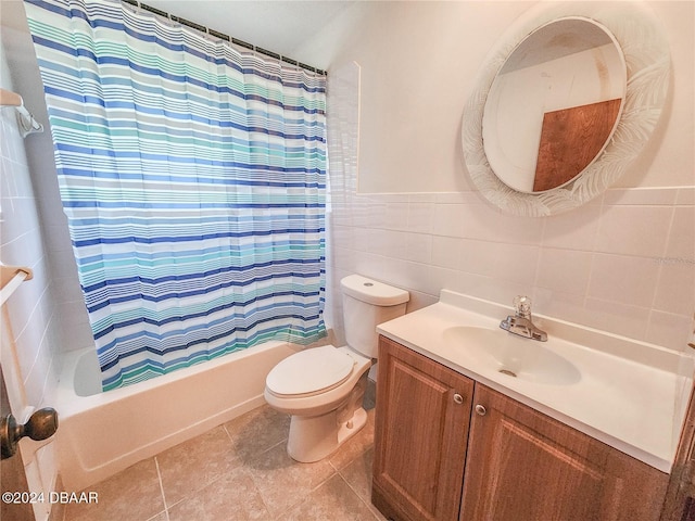 1119 Indigo Rd, Ormond Beach, FL 32174 - full bathroom featuring tile walls, toilet, vanity, shower / bath combination with curtain, and tile patterned floors