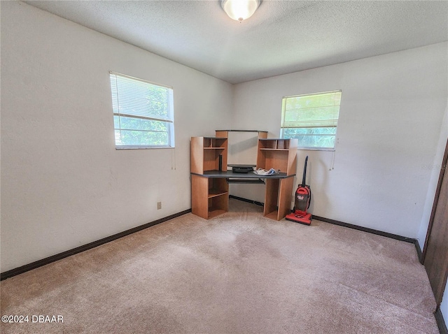 1119 Indigo Rd, Ormond Beach, FL 32174 - unfurnished office with light carpet, baseboards, and a textured ceiling