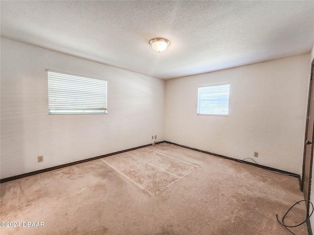 1119 Indigo Rd, Ormond Beach, FL 32174 - carpeted empty room with baseboards and a textured ceiling