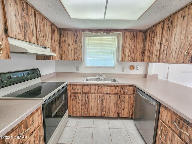 kitchen with a textured ceiling, dishwasher, sink, range with electric stovetop, and light tile patterned floors