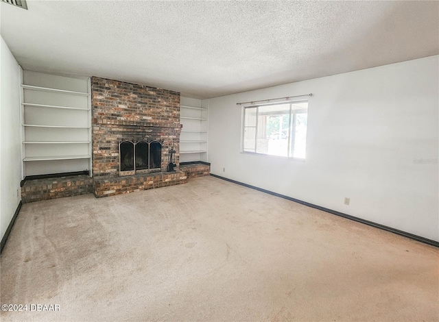 unfurnished living room with carpet, a fireplace, and a textured ceiling