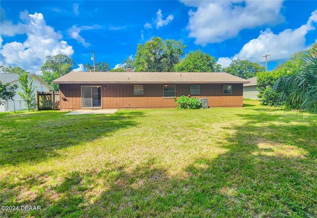 1119 Indigo Rd, Ormond Beach, FL 32174 - rear view of property with a patio, board and batten siding, cooling unit, and roof with shingles